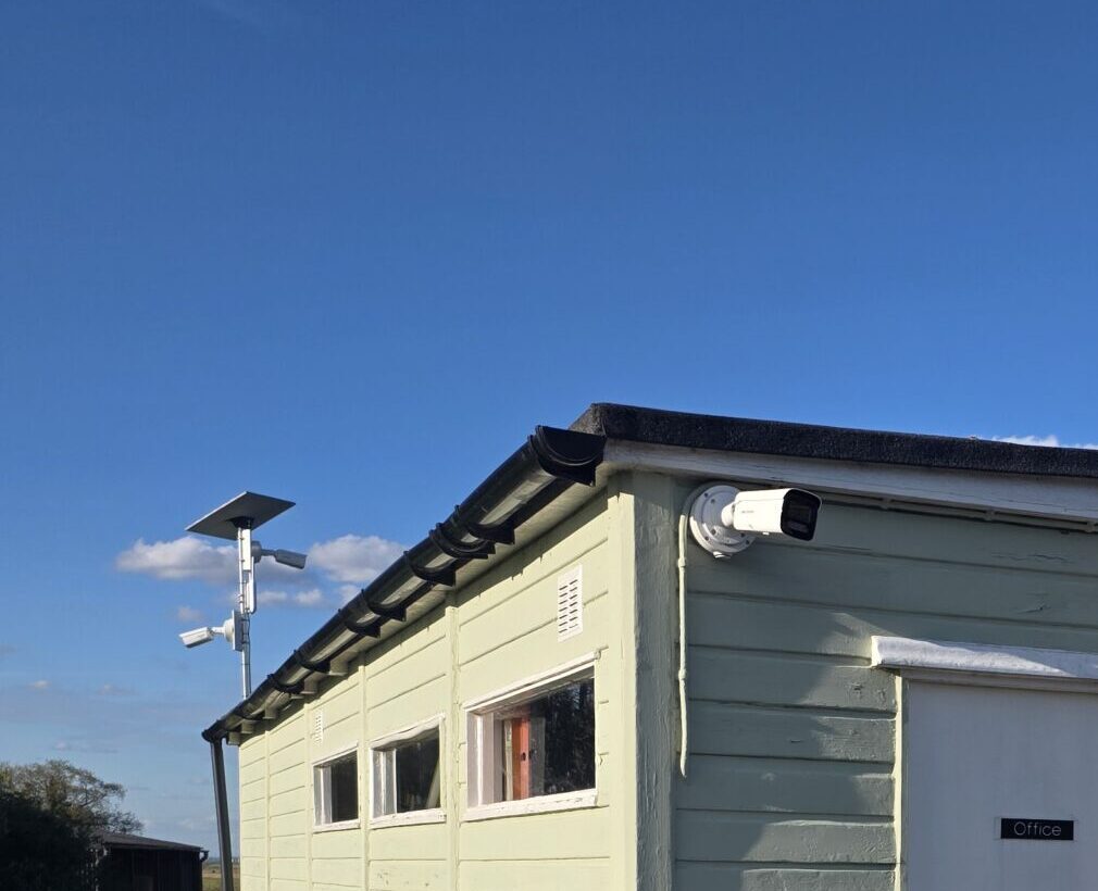 A small building fitted with external CCTV cameras and an alarm system to enhance property security.