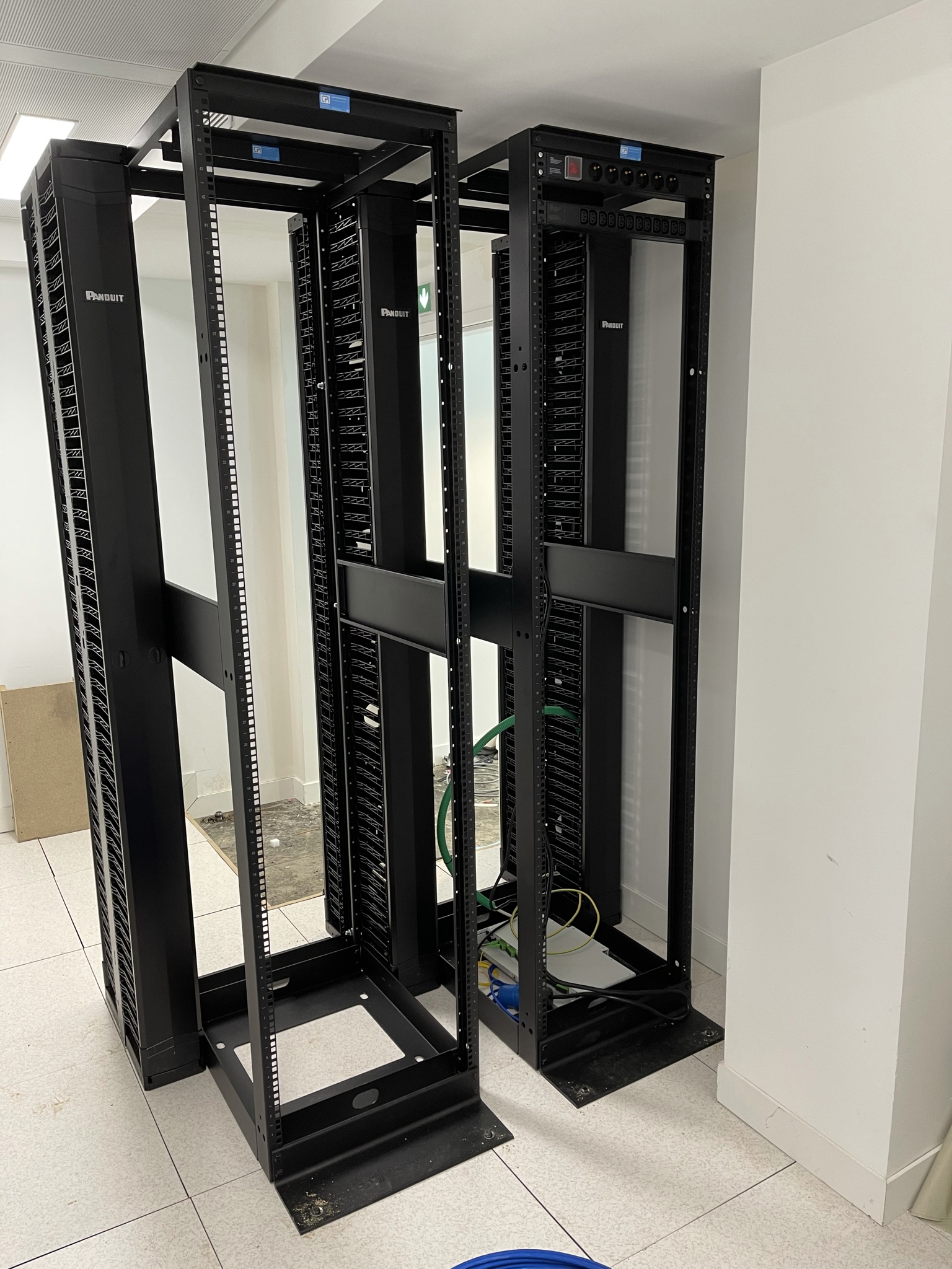 Two empty Panduit open‑frame racks prepared for patch panels, cabling, and network hardware as part of an upcoming installation.