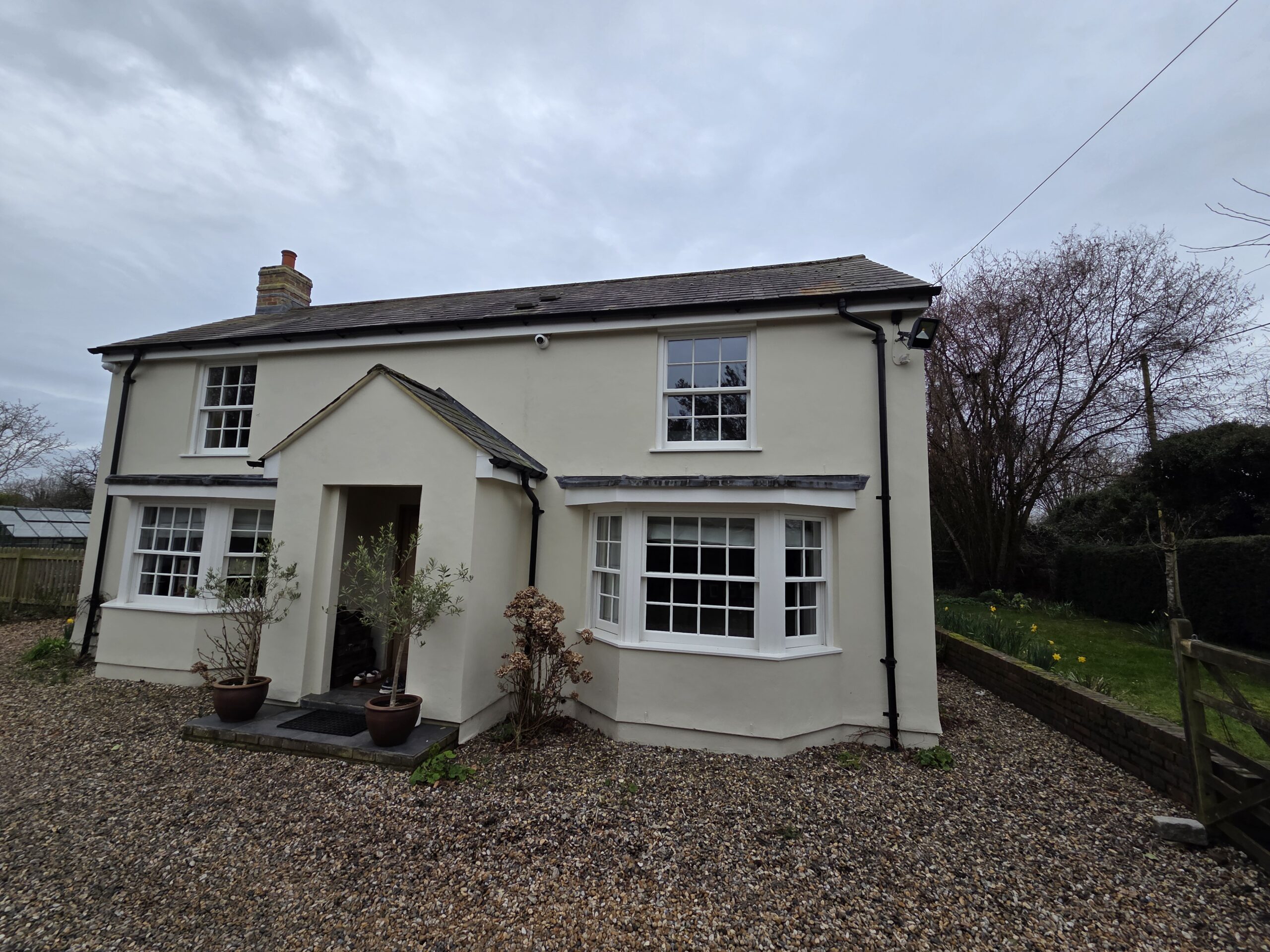 A detached residential home with externally mounted CCTV cameras installed to enhance property security.