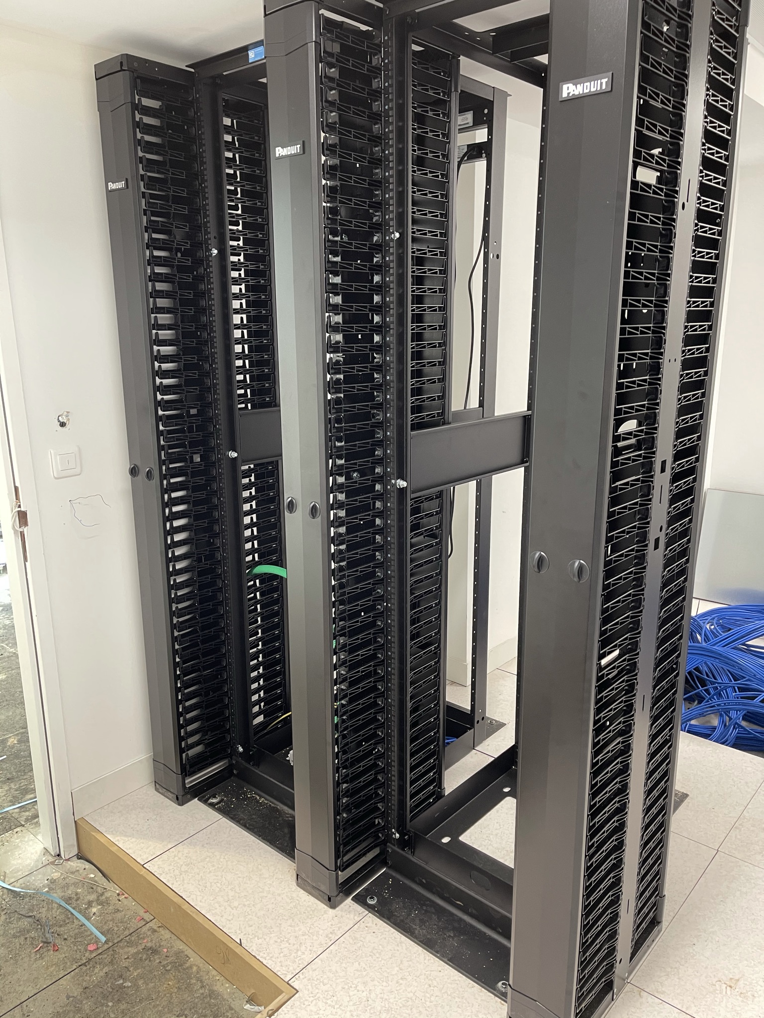 A server room with multiple Panduit open‑frame network racks installed, ready for patch panels, switches, and structured cabling.